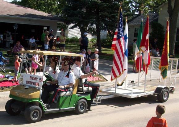 There are shriners wearing peculiar hats...